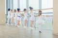 Group of seven little ballerinas standing in row and practicing Royalty Free Stock Photo