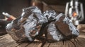 Close up of Shiny Coal Nuggets on Wooden Surface With a Lit Lantern in Background Royalty Free Stock Photo