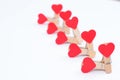 Group sex concept. Close up photo of clothespins with red hearts  on white background Royalty Free Stock Photo