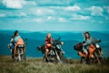 Group of sexy woman on motorcycle. Woman rider, active girsl riding on the motorbike in bikers tour on forest road Royalty Free Stock Photo