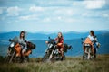 Group of sexy woman on motorcycle. Woman rider, active girsl riding on the motorbike in bikers tour on forest road Royalty Free Stock Photo