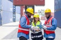 Group of shipment worker dressed in hardhat, safety vest and protective glove working during the day under sunlight. There are