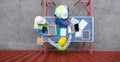 Group of shipment worker in hardhat and safety vest meeting on a table made of large solar cell panel. A large container is in the