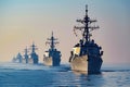 Group of Ships in Close Proximity on the Water, A row of large, imposing navy destroyers in stark contrast with a peaceful,