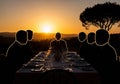 Ilhouetted figures sit at a formal dining table during sunset, Royalty Free Stock Photo