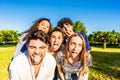 Group of silly young multiracial millennial friends making funny faces with tongue, open mouth, and squinting eyes posing for a