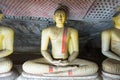 Group of sitting Buddha statues in cave buddhist temple Royalty Free Stock Photo