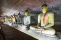 Group of sitting Buddha statues in cave buddhist temple Royalty Free Stock Photo