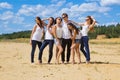 Group of six friends all in blue jeans and white Royalty Free Stock Photo