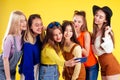 Group of six laughing girls having party summer style yellow background studio Royalty Free Stock Photo