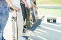 Group of skaters friends in urban contest with skateboards in their hands - Young men training with boards in skate park - Extreme