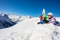 Group ski kids lay in snow together over mountain Royalty Free Stock Photo