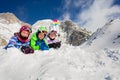 Group ski kids lay in snow together and smile Royalty Free Stock Photo