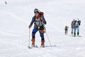 Group ski mountaineers climb on mountain on skis strapped to climbing skins