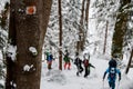 Group of skier people in bright jackets climbing the hill using skitour equipment