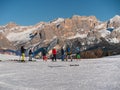 Group of Skiers, adults, teenagers and children ready to face a Descent on the Ski Slope, in the background the Beautiful Italian Royalty Free Stock Photo