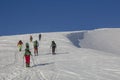 Group of skiers and snowboarders climbing up, teamwork