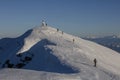 Group of skiers and snowboarders climbing up, teamwork