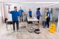 Group Of Skilled Janitors Cleaning Office Royalty Free Stock Photo
