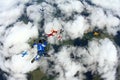Skydivers are in the cloudy sky. Royalty Free Stock Photo