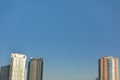 Group of skyscrapers or flat block buildings on clear blue sky background. Closeup view with copy space. Modern urban architecture Royalty Free Stock Photo