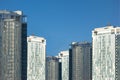 Group of skyscrapers or flat block buildings on clear blue sky background. Closeup view with copy space. Modern urban architecture Royalty Free Stock Photo