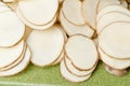 Sliced potatoes on green cutting board