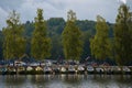 Group of small boats on the beach with excavators and industrial machines in the background. Lahti, Finland