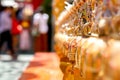 Group of small golden bells hang in Thai temple on blurry background Royalty Free Stock Photo