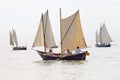 Group of small, old sailing ships with female crew