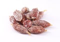 Group of small pork salamis on white background.