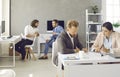 Group of smart successful business people working and communicating together in coworking office. Royalty Free Stock Photo