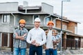 group of smiling architects in hard hats looking at camera Royalty Free Stock Photo