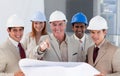 A group of smiling architects studying blueprints Royalty Free Stock Photo