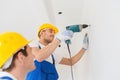 Group of smiling builders with drill indoors Royalty Free Stock Photo