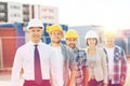 Group of smiling builders in hardhats outdoors