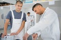 group smiling builders with plastering tools indoors Royalty Free Stock Photo