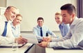 Group of smiling businesspeople meeting in office Royalty Free Stock Photo