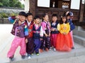 Group of smiling children dressed in Hanbok, traditional Korean dress at Namsangol Hanok Village in Seoul