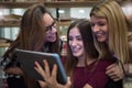 Group of smiling female students with books at school cafeteria Royalty Free Stock Photo