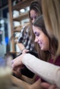 Group of smiling female students looking at tablet in library Royalty Free Stock Photo