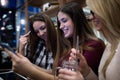 Group of smiling female students looking at tablet in library Royalty Free Stock Photo