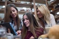 Group of smiling female students looking at tablet in library Royalty Free Stock Photo