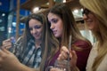 Group of smiling female students looking at tablet in library Royalty Free Stock Photo