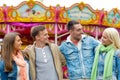 Group of smiling friends in amusement park