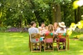 Group of smiling friends enjoying outdoor birthday party during