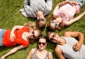 Group of smiling friends lying on grass outdoors Royalty Free Stock Photo