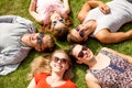 Group of smiling friends lying on grass outdoors Royalty Free Stock Photo