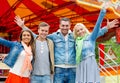 Group of smiling friends waving hands