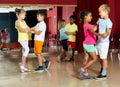 Group of smiling kids dancing salsa dance